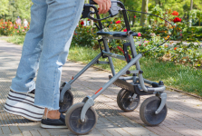 A lady with mobility issues using a walking aid